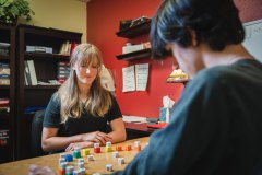 Instructor working with student in hands-on cognitive task.