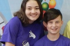 Happy girl and boy in matching Carnival t-shirts.