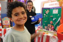 Children at hands-on carnival displays and games.